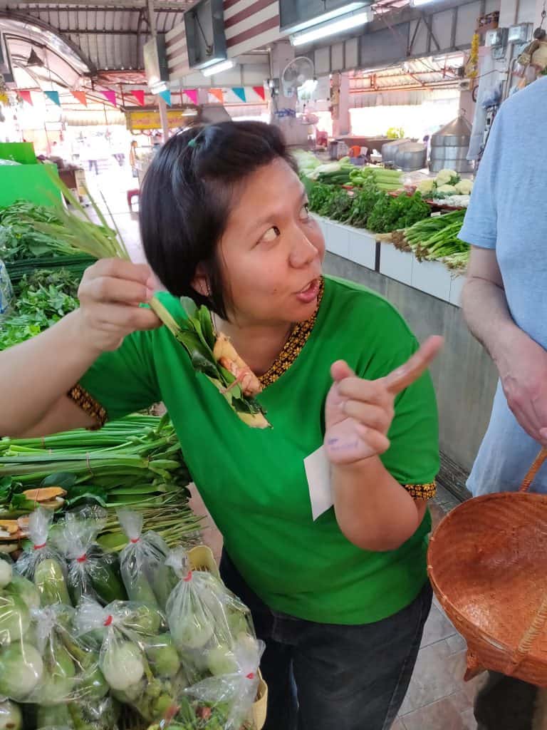 Cooking instructor showing us foods in the market