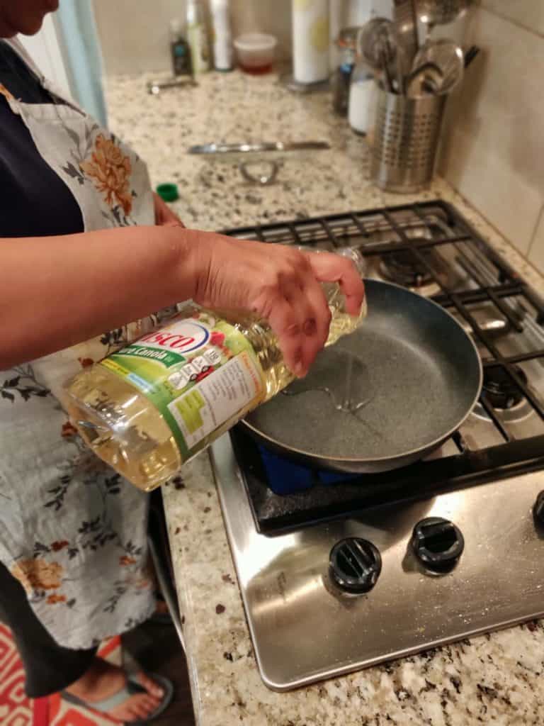 Pouring oil in pan on stove