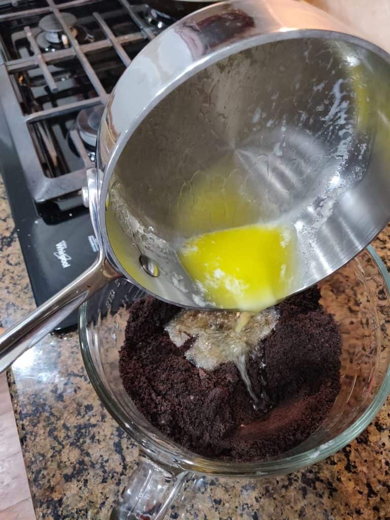Adding melted butter to crushed oreos