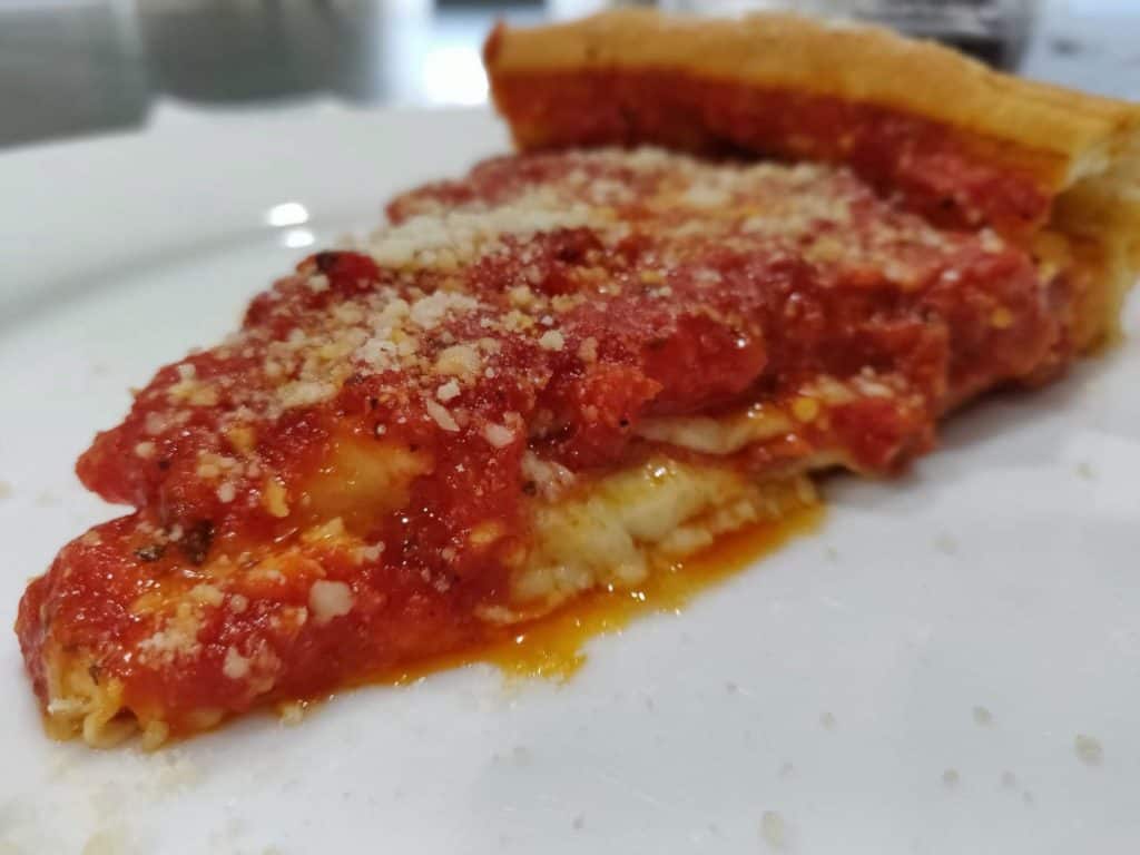 Slice of deep dish Chicago style pizza