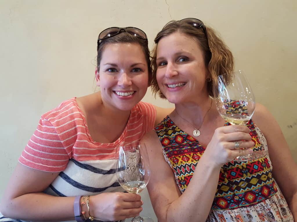 Leslie and Mindee holding wine glasses