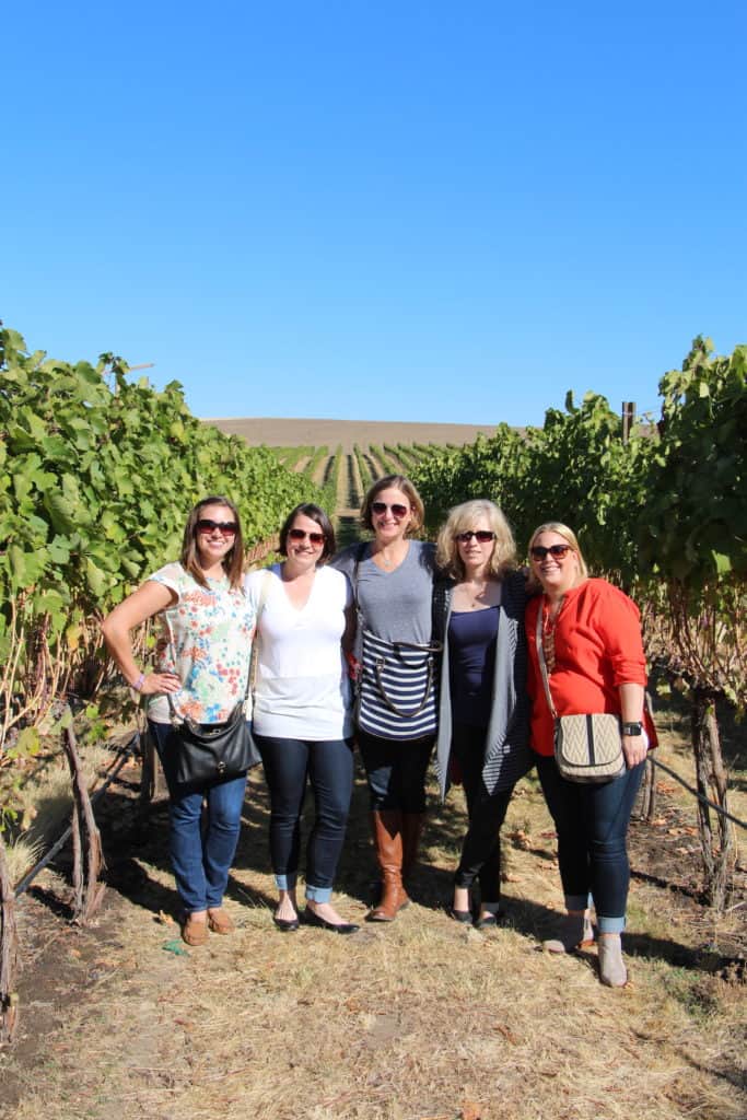 Group photo in front of wine vines