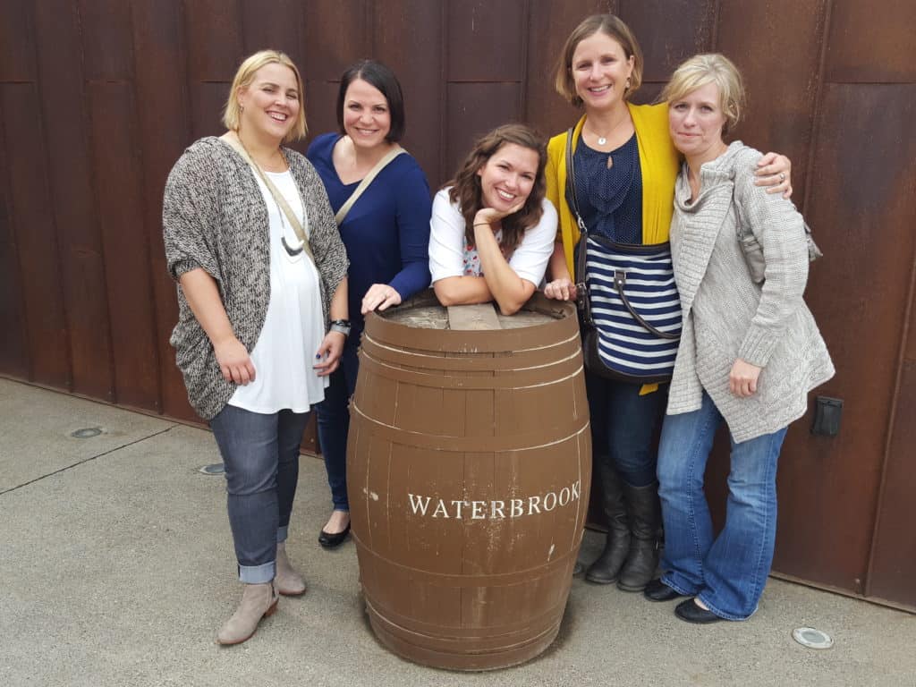 Group photo by wine barrel