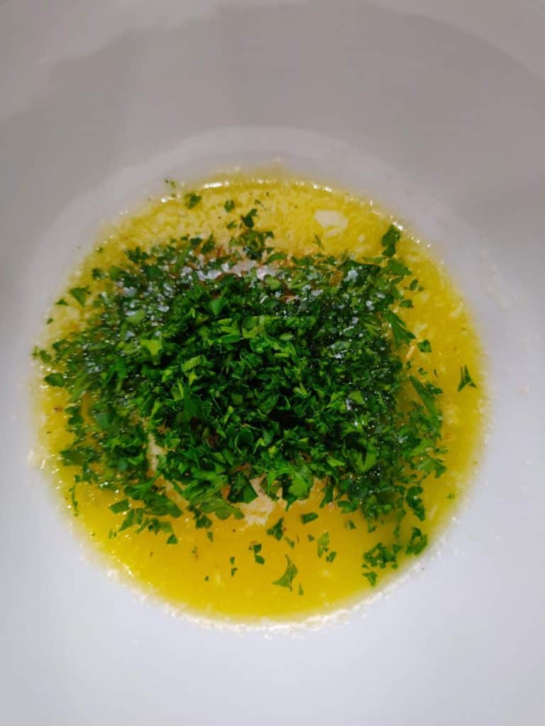 Melted Butter, spices and shopped parsley in bowl