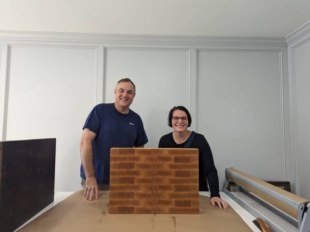 The owner John and Dusti with new cutting board. 