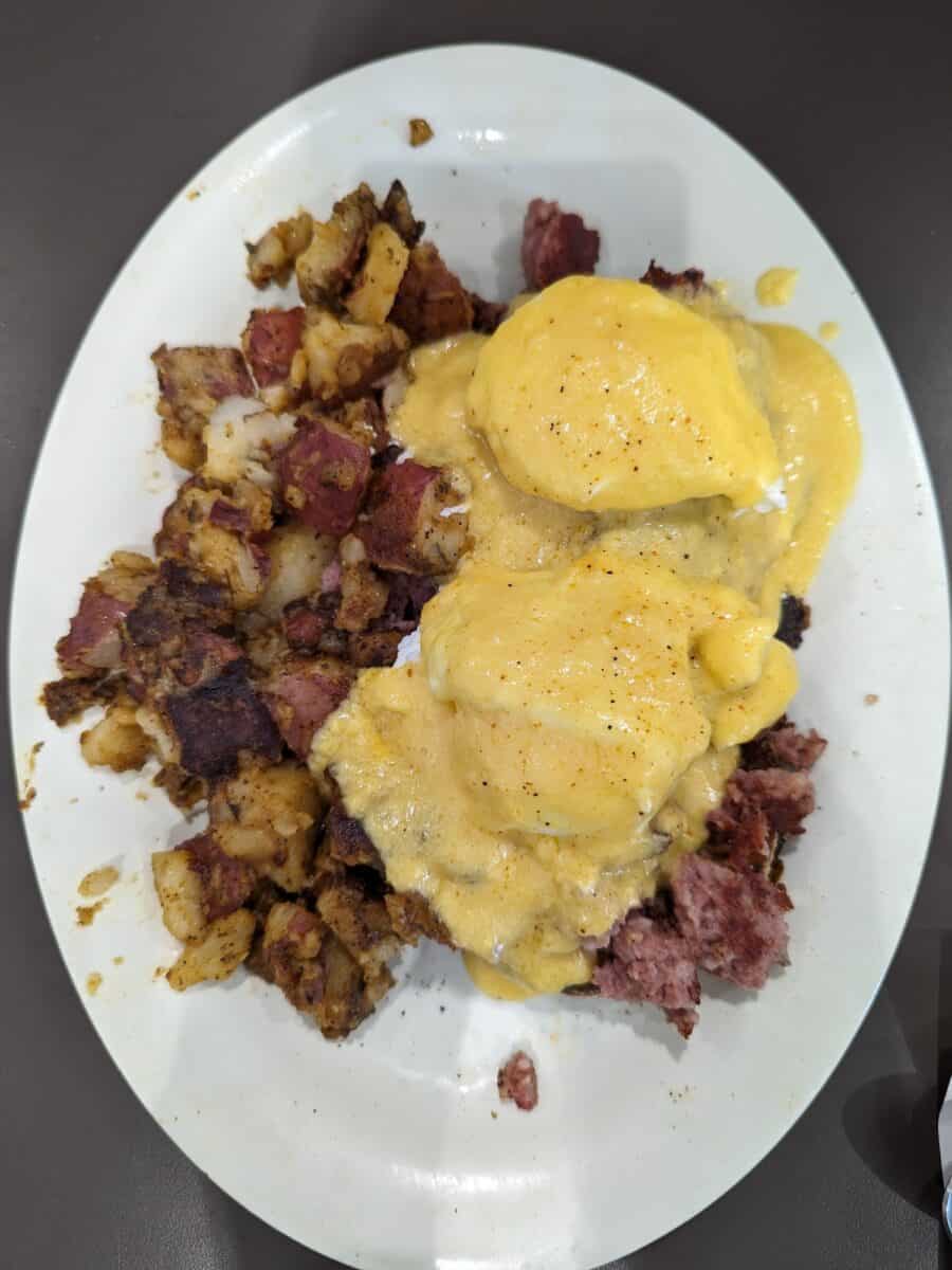 Eggs Benedict with corned beef hash on a plate