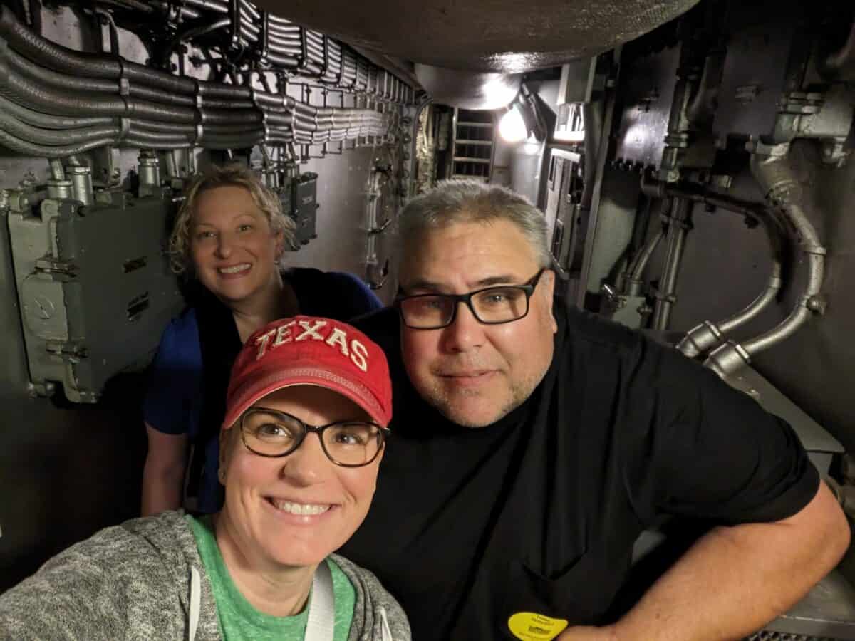 Shelly, Mike and Dusti standing on hallway on naval ship